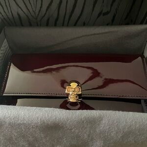 Alexander McQueen Continent Wallet in Bordeaux with Gold Skull Accent